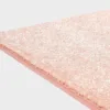 Rosan värinen VM Carpet Hattara matto. Lähikuva maton kulmasta, josta näkyy kanttaus ja maton materiaali.