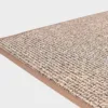 VM-Carpet-Tweed-32-vaalea-beige Vaalean beige VM Carpet Tweed matto. Lähikuva maton kulmasta, josta näkyy kanttaus ja maton materiaali.