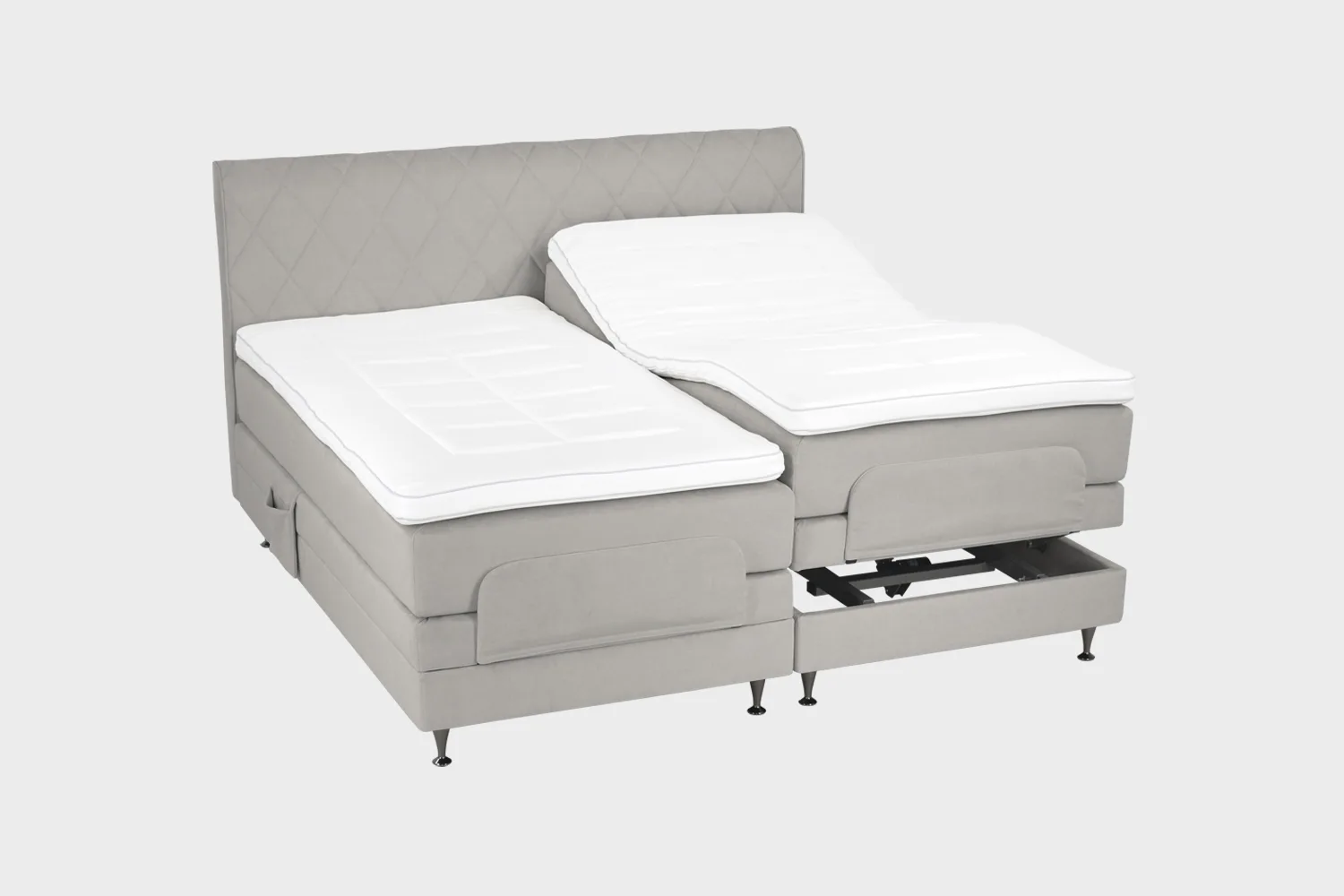 Harmaa moottorisänky 200x200 cm mustilla jaloilla sekä samanvärisellä sängynpäädyllä. Parisänky on kuvattuna viistosti toisen sänkypuoliskon päädyt aavistuksen koholla vaaleaa taustaa vasten.